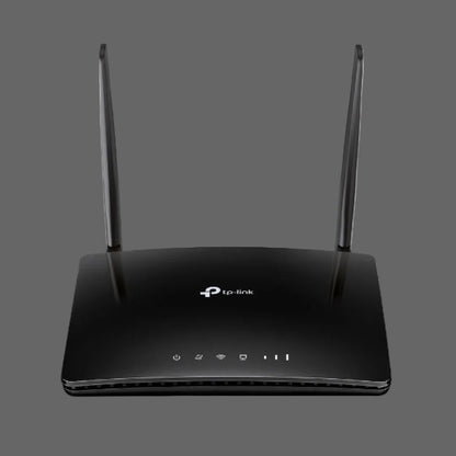 Black TP-Link router with antennas on a white background